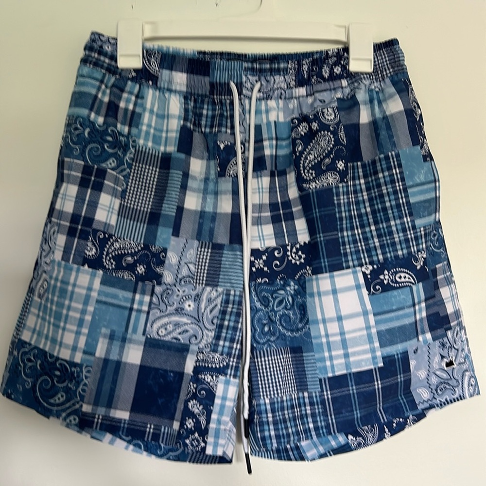 Bold, blue/white, mixed patterned men’s swim trunks